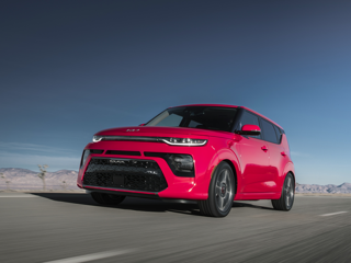 A Red Kia Soul on the road