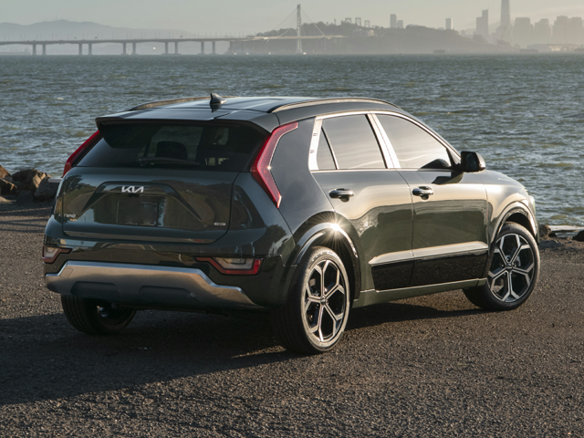 A black Kia Niro by the coast