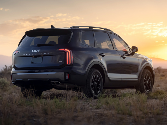A black Kia Telluride parked outside near the sunset