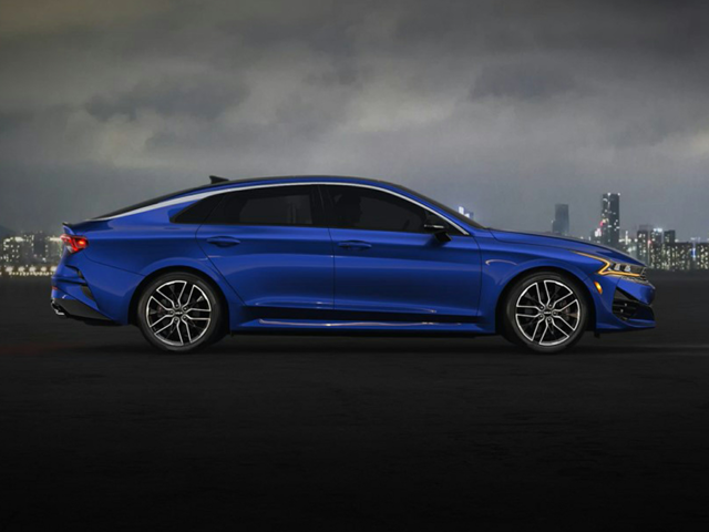 A blue Kia sedan parked outside