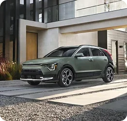 Kia Niro parked in front of a modern home