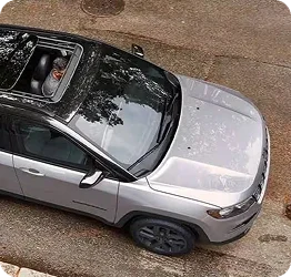 Overhead view of a used Jeep Compass with an open sunroof