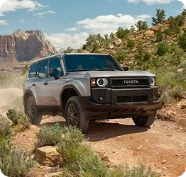 Used Toyota Land Cruiser driving on a desert trail
