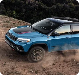 Used Jeep Compass Trailhawk climbing a dirt hill