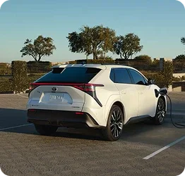 Used Toyota bZ4X parked at an electric vehicle charger